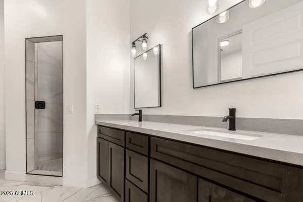a bathroom with a double vanity sink a and mirror