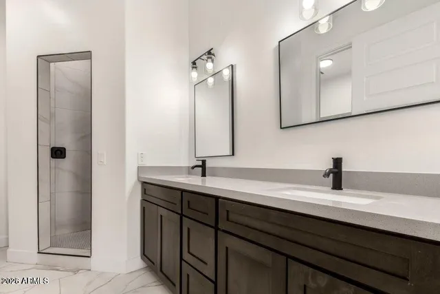 a bathroom with a double vanity sink a and mirror