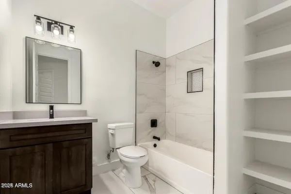 a bathroom with a toilet a sink a bathtub and a window