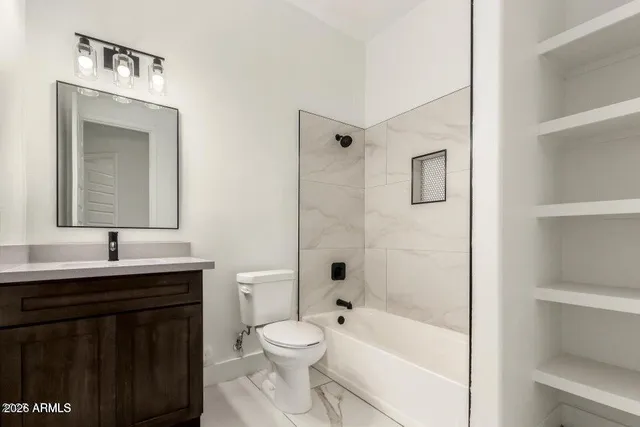 a bathroom with a toilet a sink a bathtub and a window