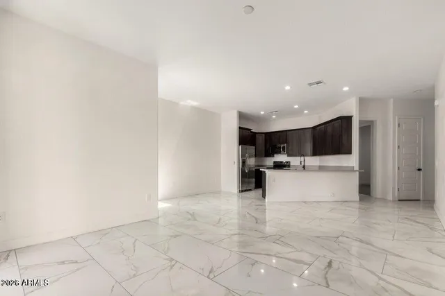 a view of a kitchen with a sink and a living room view