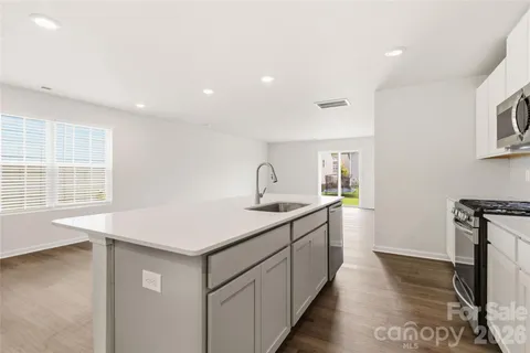 a kitchen with sink and cabinets