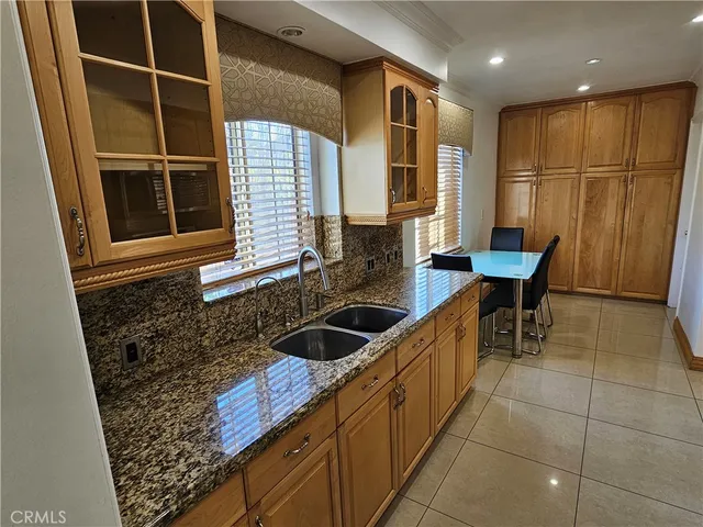 a kitchen with granite countertop a sink and cabinets