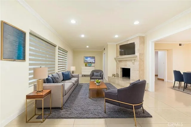 a living room with furniture a fireplace and a flat screen tv