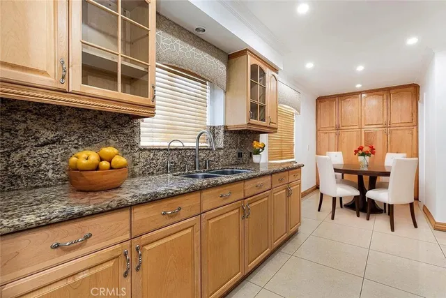 a kitchen with stainless steel appliances granite countertop a sink and cabinets
