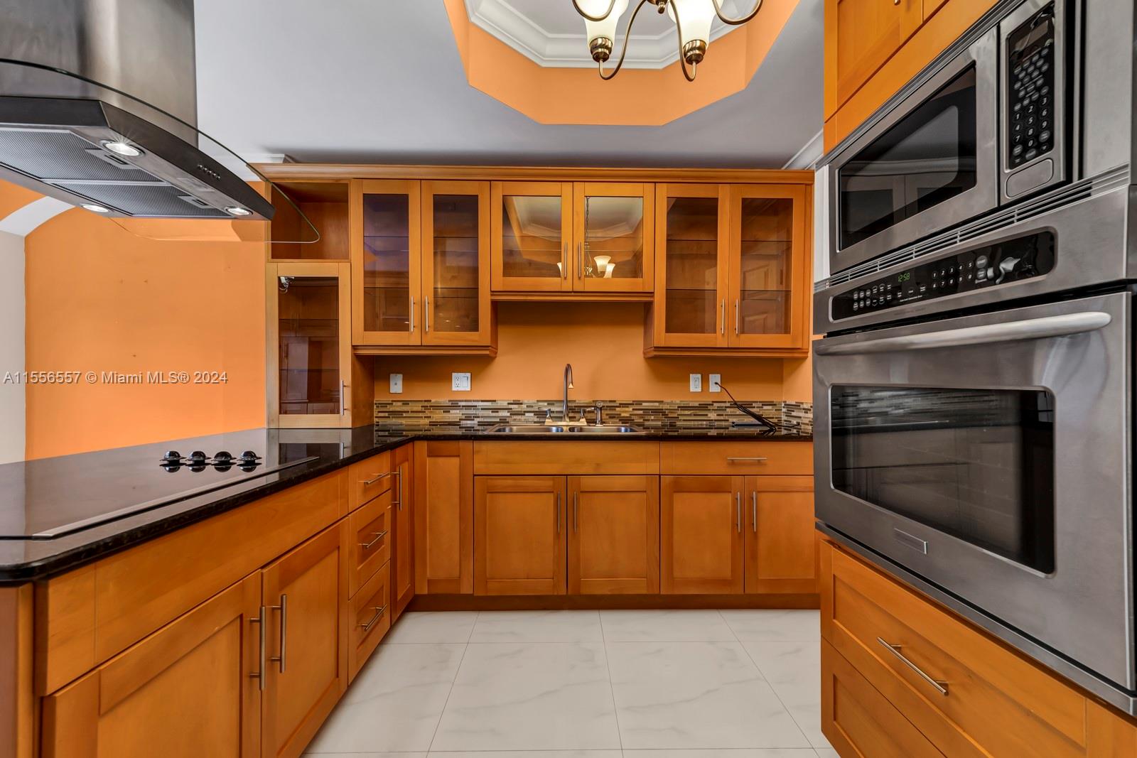 4014 Southwest 144th Place Miami, FL 33175 - Photo 20 of 50 a kitchen with stainless steel appliances granite countertop a stove and a sink