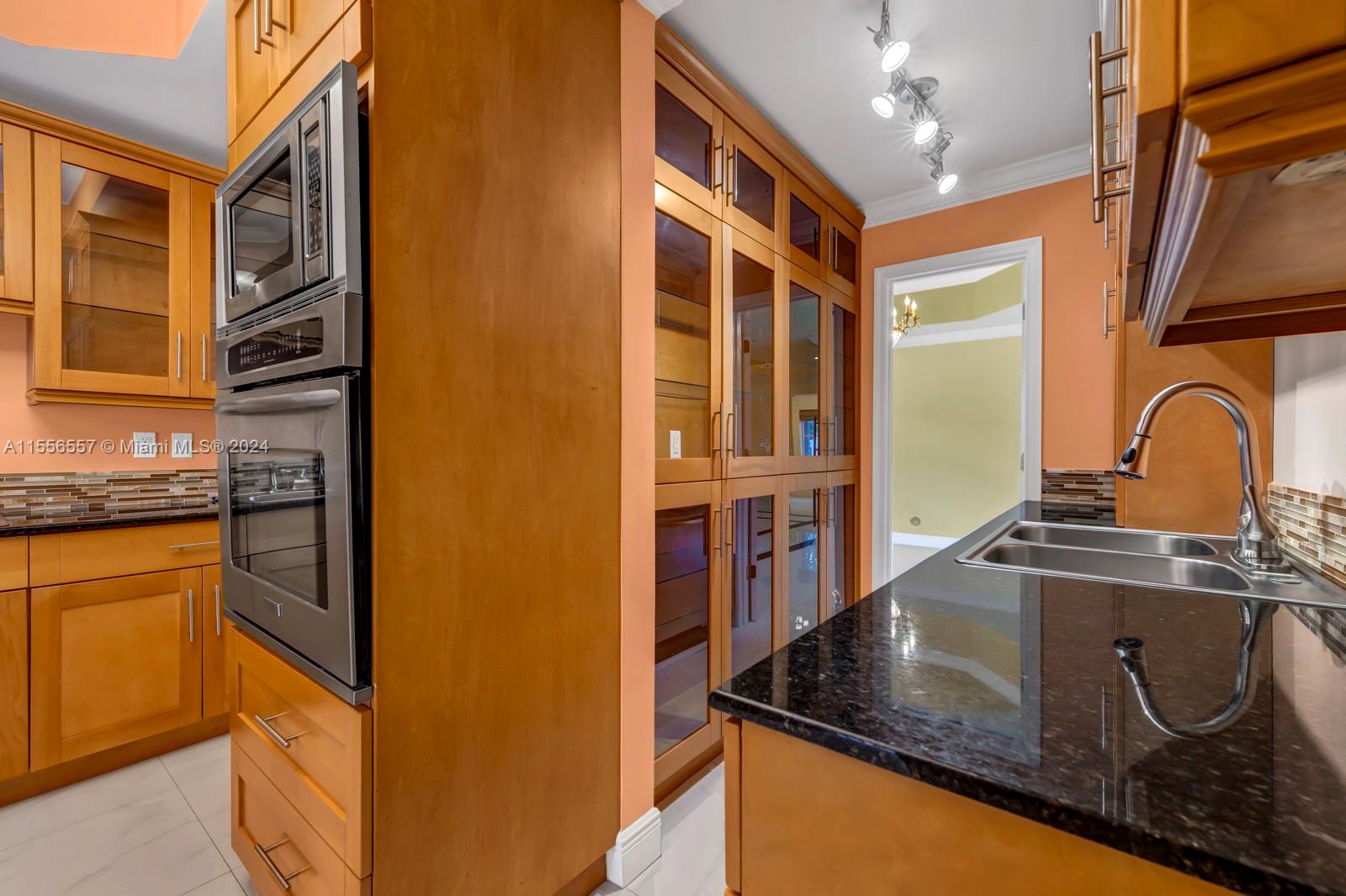 4014 Southwest 144th Place Miami, FL 33175 - Photo 21 of 50 a kitchen with stainless steel appliances granite countertop a sink and a stove top oven