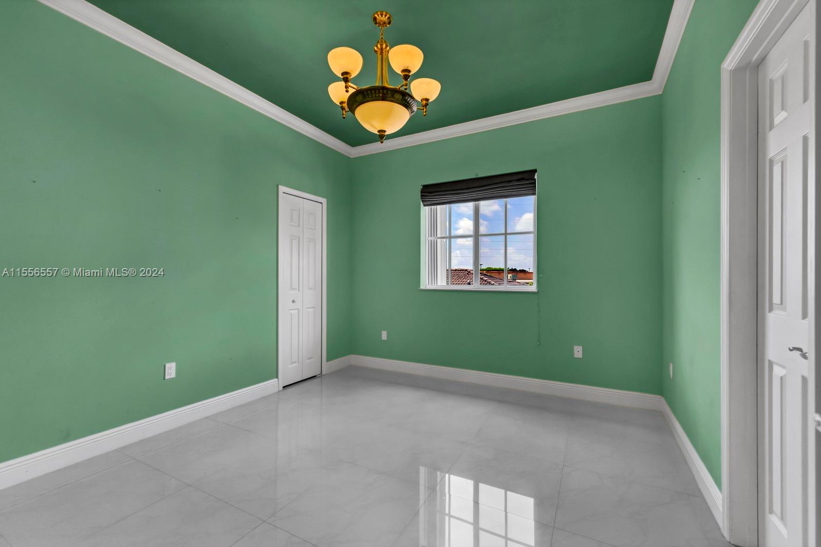 4014 Southwest 144th Place Miami, FL 33175 - Photo 39 of 50 a view of an empty room with a window and wooden floor