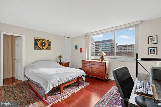 a bed room with a bed and a desk