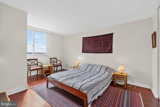 a bedroom with a bed a table and chair