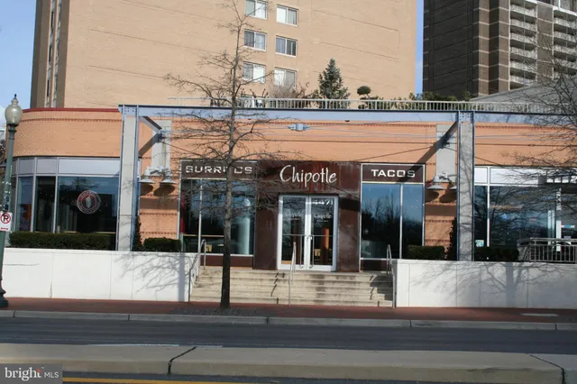 a view of a cafe with a table and chairs under an umbrella