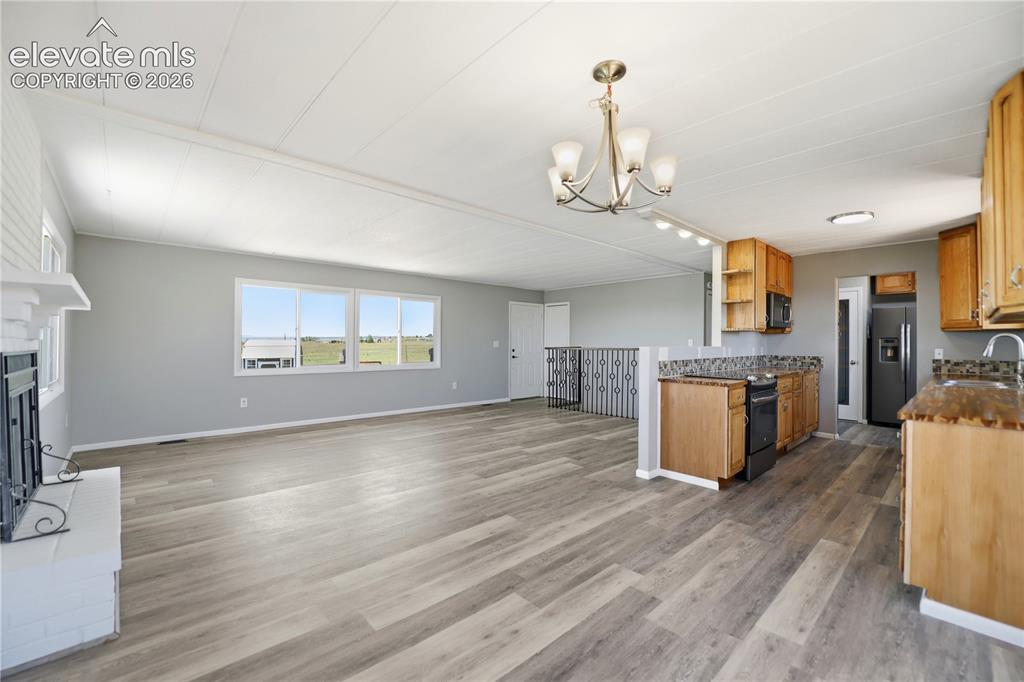 19027 Murphy Road Peyton, CO 80831 - Photo 7 of 48 Vinyl Plank, Fireplace, Sliding Door To Deck, Dining Area