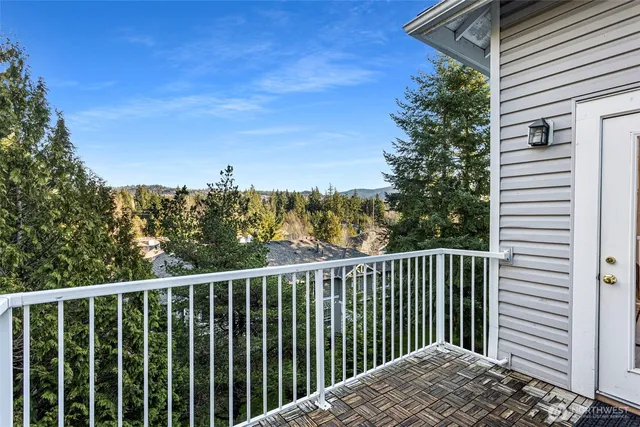 a view of a balcony with wooden floor and fence