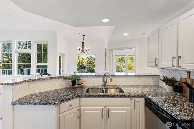 a kitchen with granite countertop a sink and a window