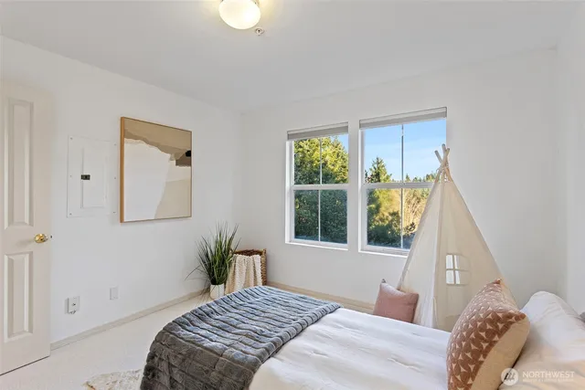 a bedroom with a bed and a window