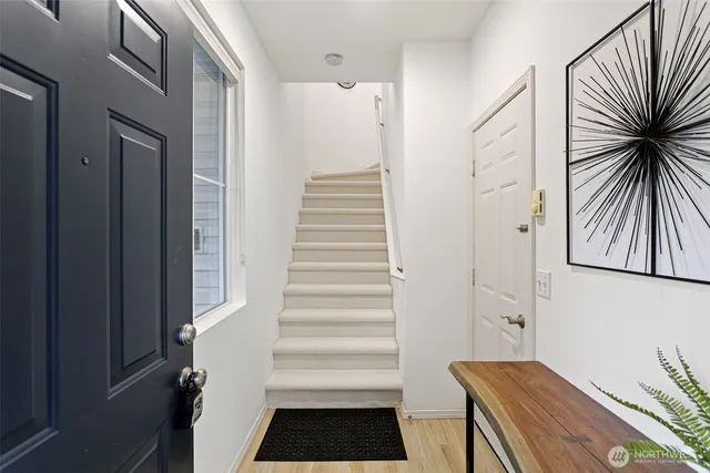 a view of entryway with wooden floor and stairs