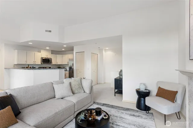a living room with furniture and kitchen view
