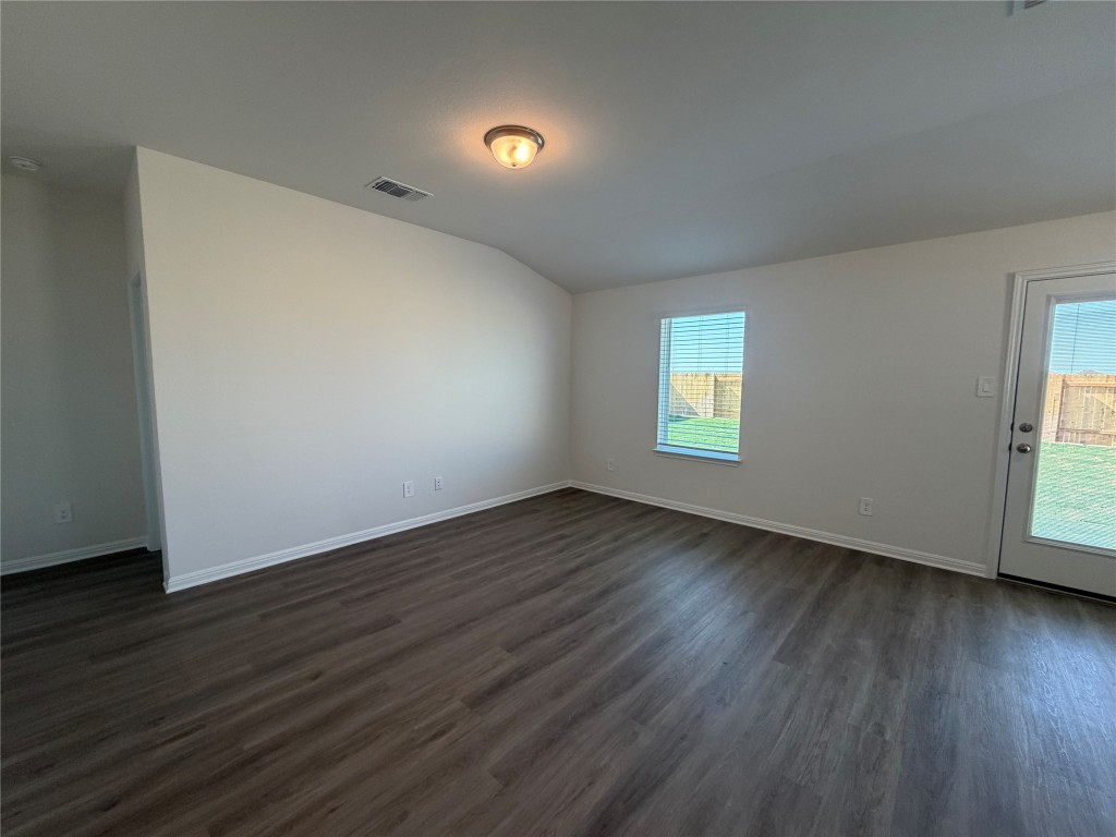 121 Honey Bee Road Jarrell, TX 76537 - Photo 5 of 10 Unfurnished room featuring dark wood-style flooring and lofted ceiling