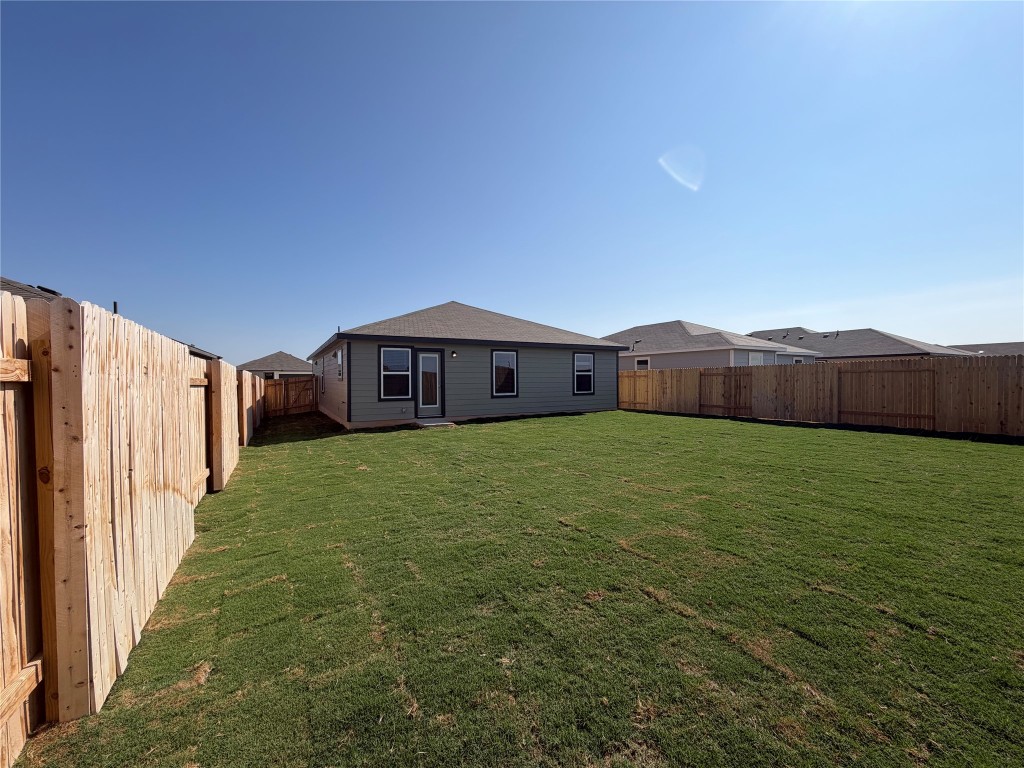 121 Honey Bee Road Jarrell, TX 76537 - Photo 6 of 10 Rear view of house with a fenced backyard