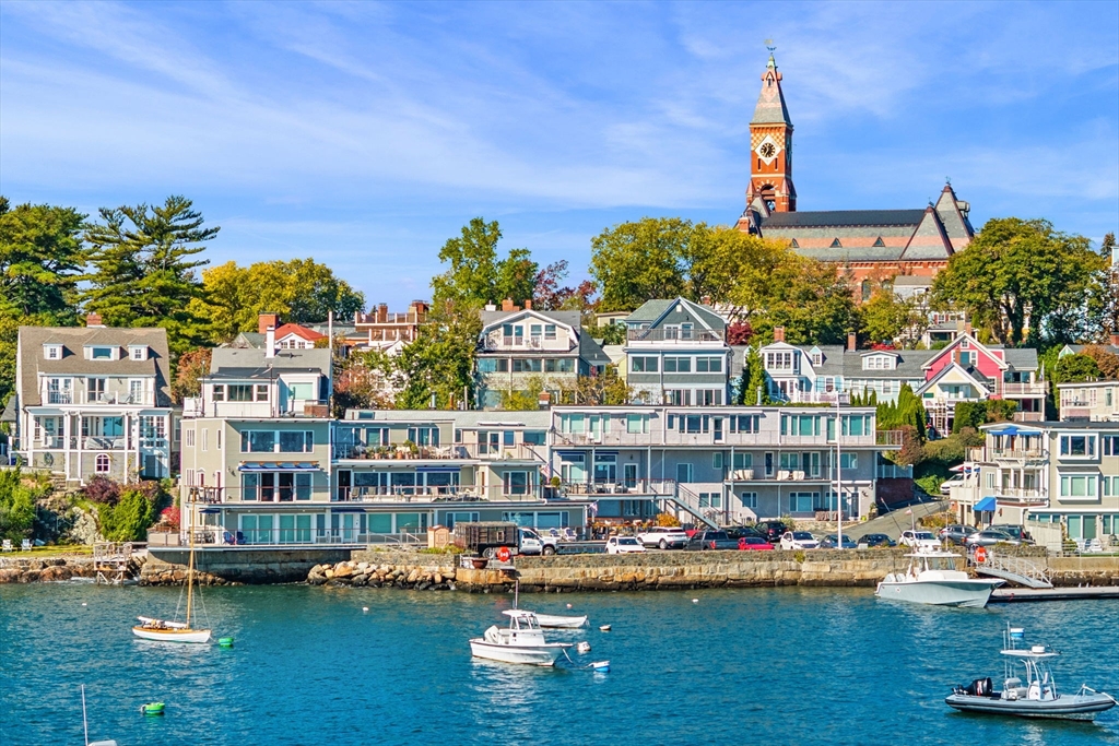 a view of a lake with a building and trees in the background