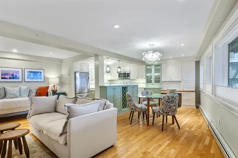 a living room with furniture a dining table and kitchen view
