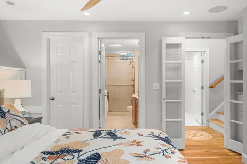 a bedroom with a bed and a lamp