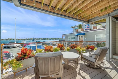 a view of a chairs and table in patio with a lake view