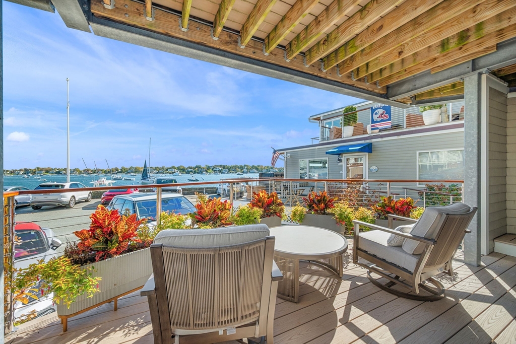 24 Lee Street, Unit B10 Marblehead, MA 01945 - Photo 3 of 33 a view of a chairs and table in patio with a lake view