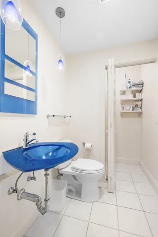 a bathroom with a sink toilet and a mirror
