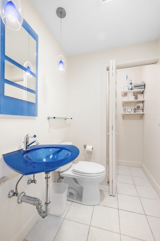 24 Lee Street, Unit B10 Marblehead, MA 01945 - Photo 32 of 33 a bathroom with a sink toilet and a mirror