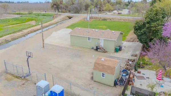 an aerial view of a house with a yard and lake view