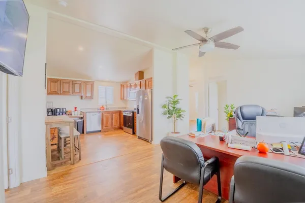 a view of a workspace with furniture and a potted plant