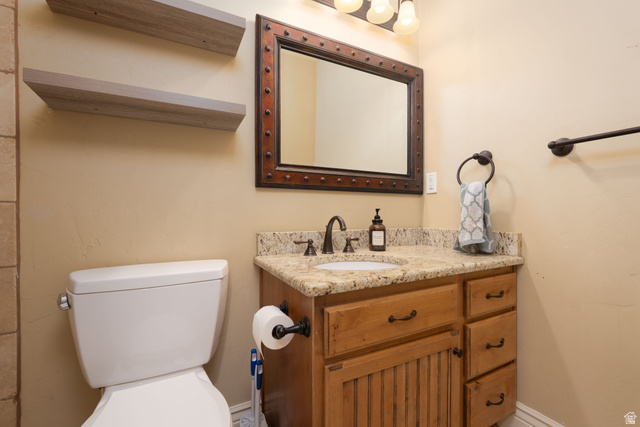 687 South 2080th Street East Springville, UT 84663 - Photo 33 of 149 Bathroom featuring a natural wood vanity with stone-finish countertop, undermount sink, and oil-rubbed bronze fixtures
