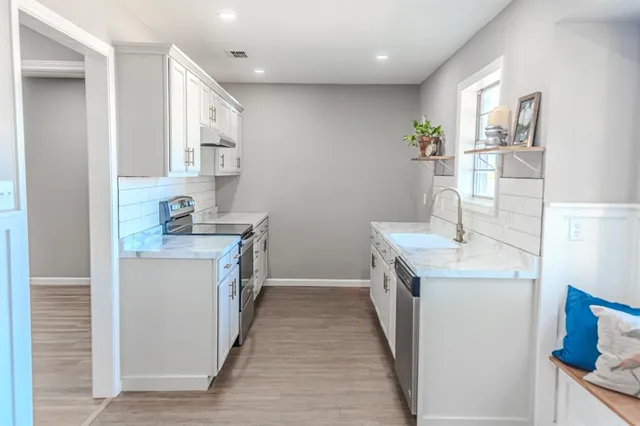 a sink with a granite countertop window