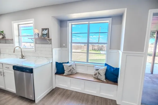 a living room with a bed furniture and a window