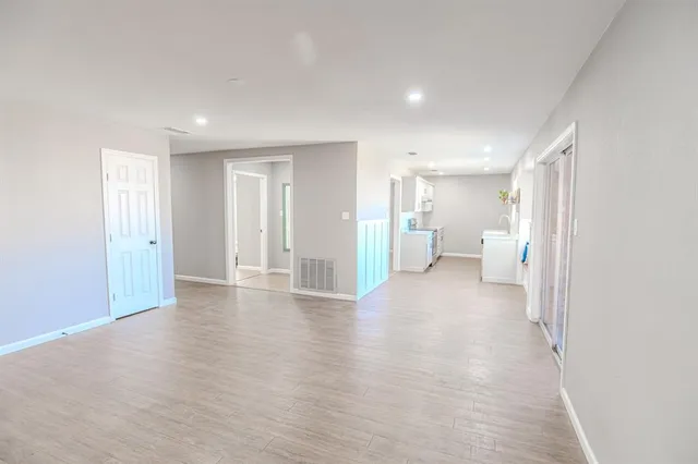 a kitchen with stainless steel appliances granite countertop a sink a stove and wooden floors