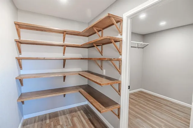 a view of walk in closet with empty racks