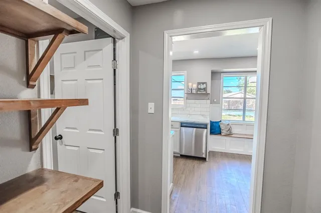 a view of a hallway and a livingroom with furniture