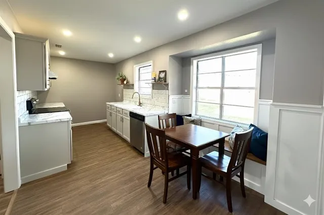a view of a dining room with furniture and wooden floor
