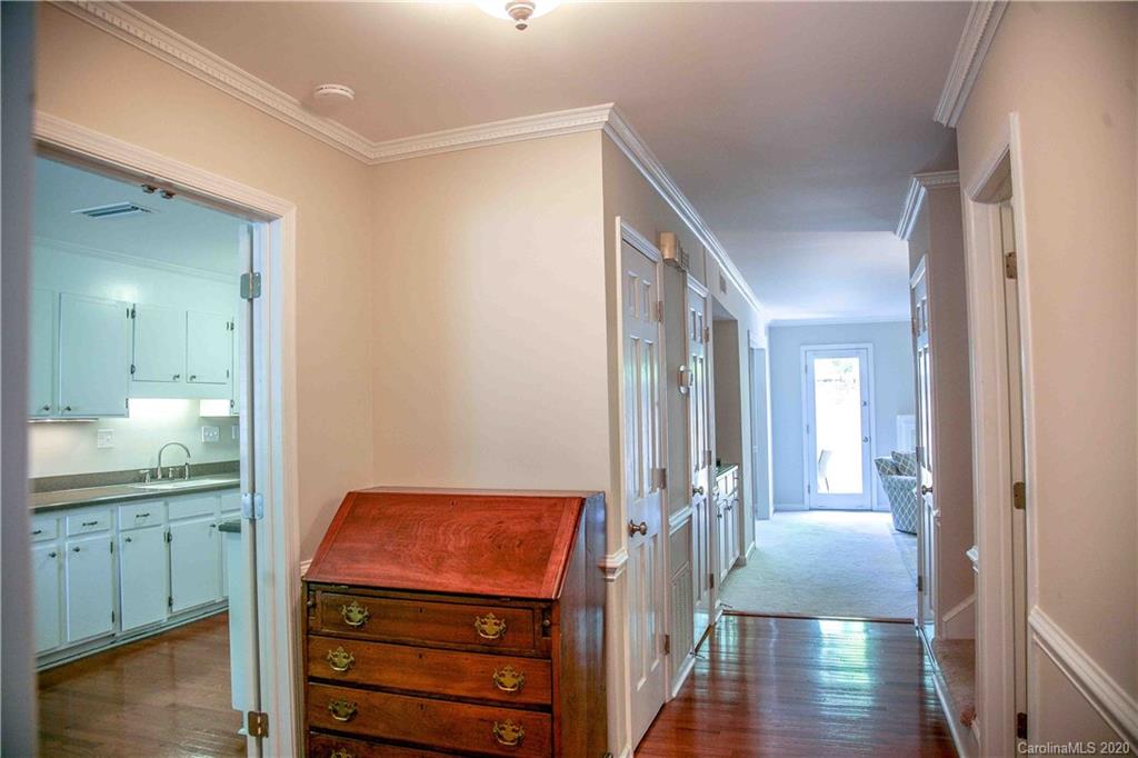 4417 Simsbury Road Charlotte, NC 28226 - Photo 2 of 42 a view of a hallway with wooden floor windows and a bathroom