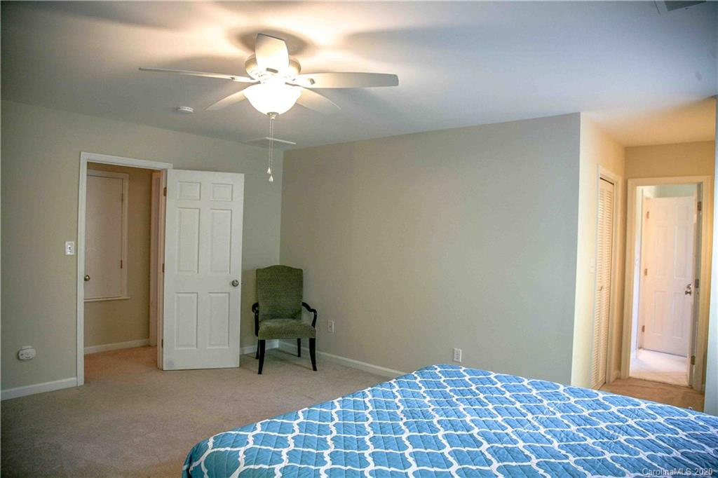 4417 Simsbury Road Charlotte, NC 28226 - Photo 19 of 42 a bedroom with a bed and a chandelier