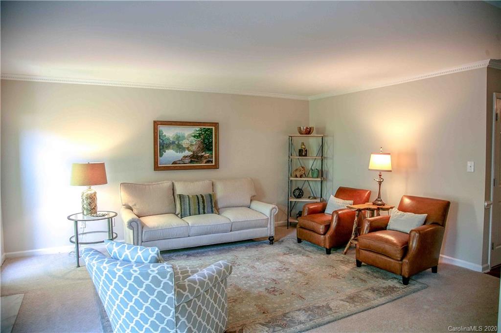 4417 Simsbury Road Charlotte, NC 28226 - Photo 3 of 42 a living room with furniture a lamp and a lamp