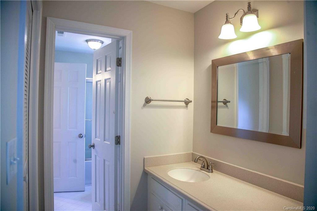 4417 Simsbury Road Charlotte, NC 28226 - Photo 21 of 42 a bathroom with a granite countertop sink and a mirror
