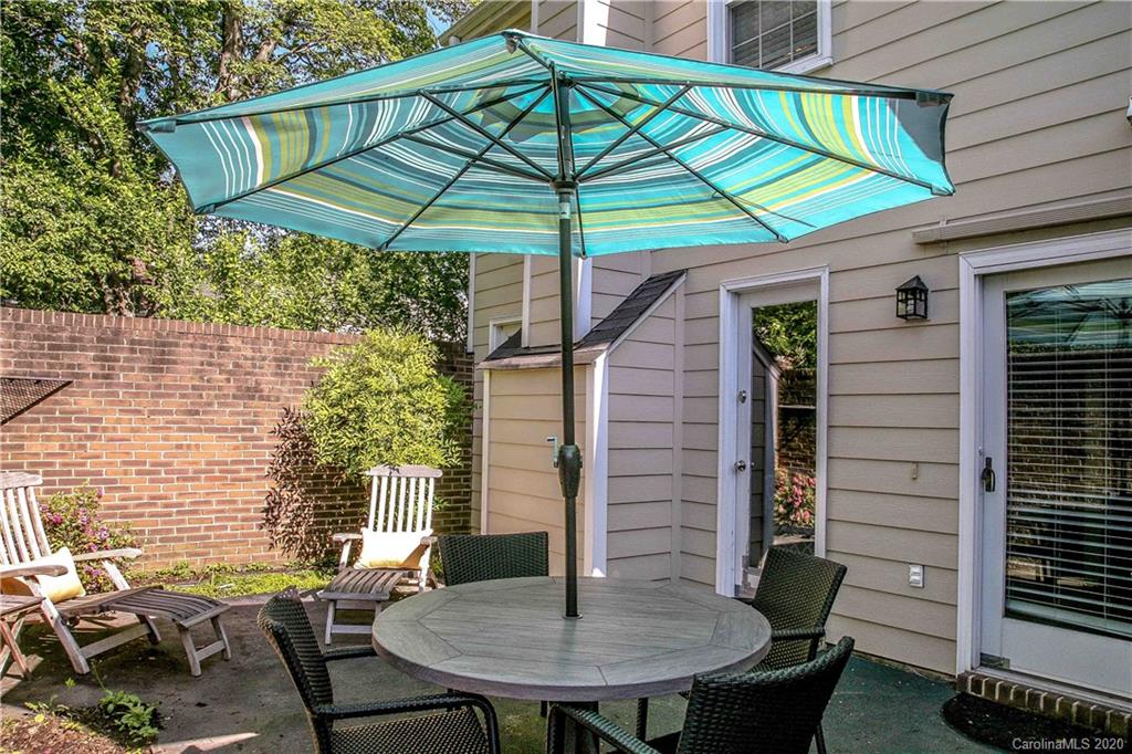 4417 Simsbury Road Charlotte, NC 28226 - Photo 26 of 42 a backyard of a house with table and chairs