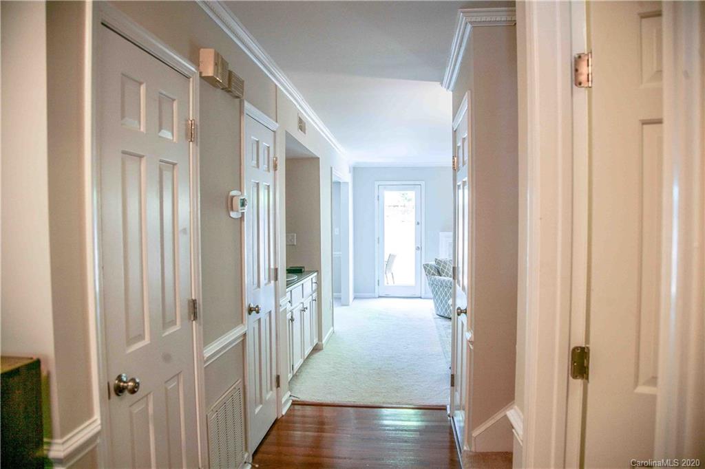 4417 Simsbury Road Charlotte, NC 28226 - Photo 28 of 42 a view of a hallway with a wooden door