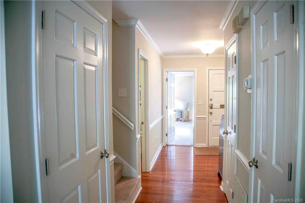 4417 Simsbury Road Charlotte, NC 28226 - Photo 31 of 42 a view of a hallway with wooden floor and a bathroom