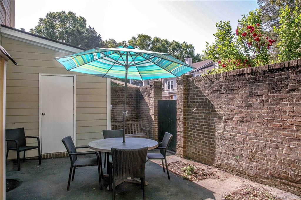 4417 Simsbury Road Charlotte, NC 28226 - Photo 36 of 42 a patio with a table and chairs