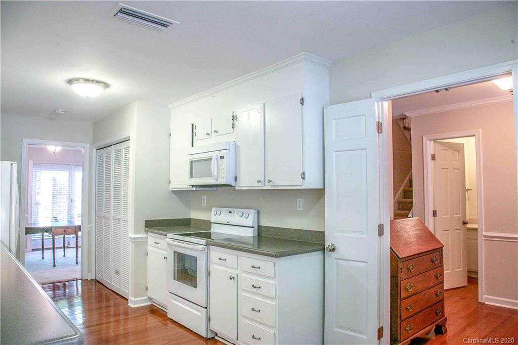 4417 Simsbury Road Charlotte, NC 28226 - Photo 9 of 42 a kitchen that has a lot of cabinets in it and wooden floors