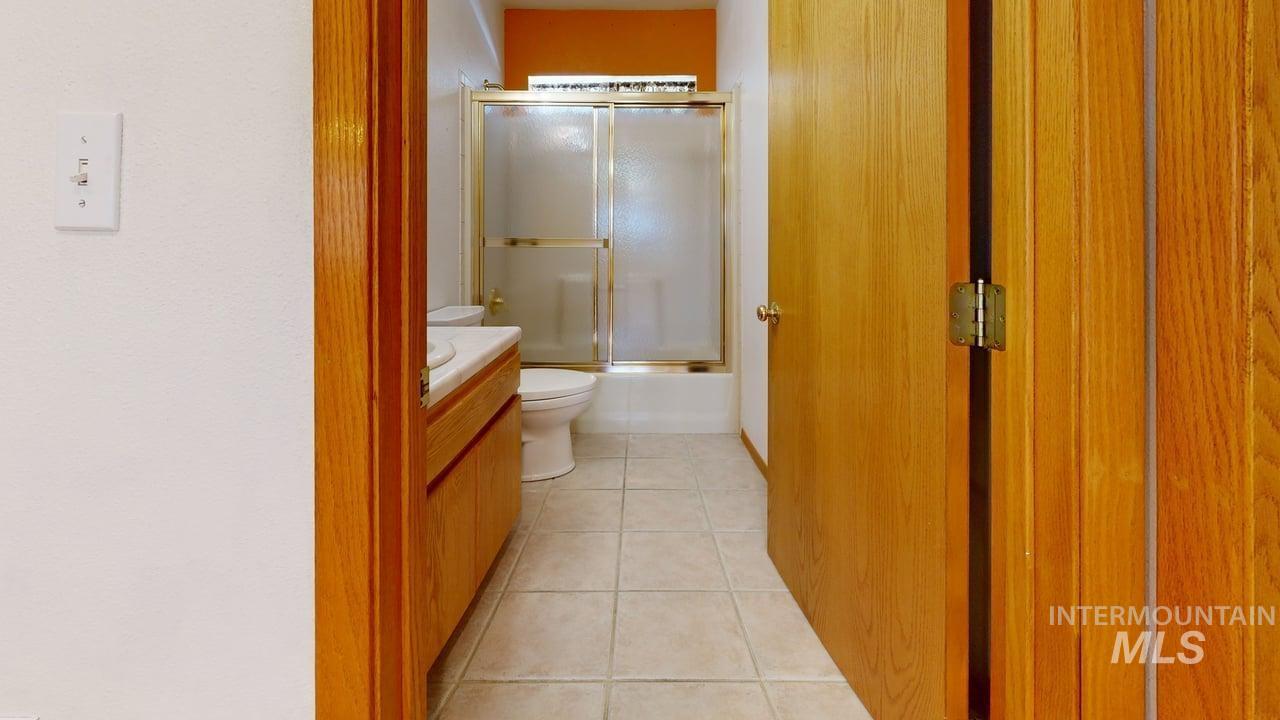 2794 9th Avenue Clarkston, WA 99403 - Photo 22 of 34 Bathroom with light tile patterned flooring, vanity, and combined bath / shower with glass door