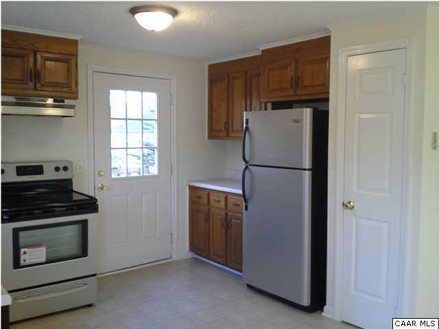 94 Carnation Road Ruckersville, VA 22968 - Photo 5 of 34 a kitchen with a refrigerator and a stove top oven